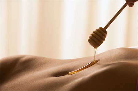Honey Dripping on Woman's Stomach Stock Photo - Rights-Managed, Code: 700-00429655