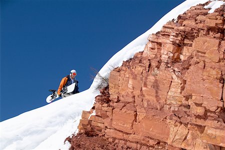 Man Climbing Hill with Snowboard Stock Photo - Rights-Managed, Code: 700-00429851