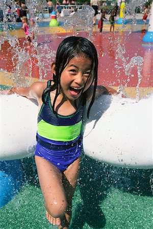 Girl Playing in Water at Park Stock Photo - Rights-Managed, Code: 700-00438971