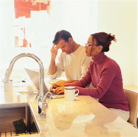 Couple Doing Computer Banking in Kitchen Stock Photo - Rights-Managed, Code: 700-00439984