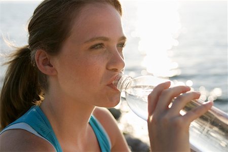 satisfied (thirst) - Girl Drinking From Water Bottle Foto de stock - Con derechos protegidos, Código: 700-00430052