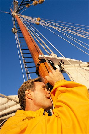 simsearch:6119-08740148,k - Man with Binoculars on Sailboat Stock Photo - Rights-Managed, Code: 700-00458087