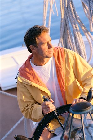 simsearch:693-06019372,k - Man Steering Boat Stock Photo - Rights-Managed, Code: 700-00458083