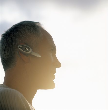 simsearch:700-00522448,k - Man Using Wireless Headset Stock Photo - Rights-Managed, Code: 700-00458269