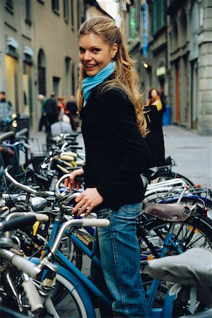 simsearch:700-00458301,k - Woman Grabbing Bike from Rack, Florence, Italy Fotografie stock - Rights-Managed, Codice: 700-00458279