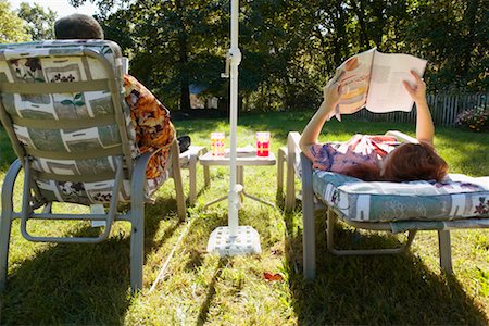 retired man in hawaiian shirt - Couple Sitting in Patio Chairs in Backyard Stock Photo - Rights-Managed, Code: 700-00458389