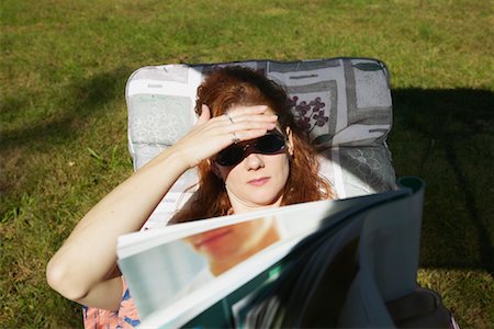 person in hawaiian shirt - Woman Reading Magazine in Patio Chair Stock Photo - Rights-Managed, Code: 700-00458391