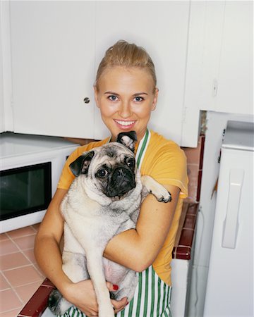 dogs and woman in kitchen - Portrait of Woman Holding Dog Stock Photo - Rights-Managed, Code: 700-00452737