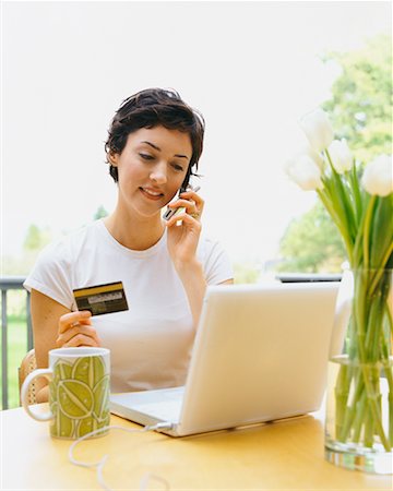 phone young woman card - Woman Paying Bills and Talking on Cellphone Stock Photo - Rights-Managed, Code: 700-00452936