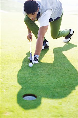 simsearch:400-08160849,k - Golfer Using Golf Club as Pool Cue Foto de stock - Con derechos protegidos, Código: 700-00453075
