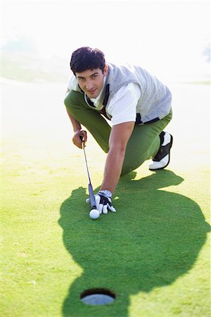 simsearch:400-08160849,k - Golfer Using Golf Club as Pool Cue Foto de stock - Con derechos protegidos, Código: 700-00453077