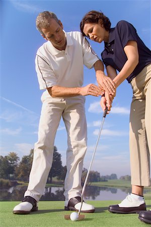 Man Teaching Woman To Putt Stock Photo - Rights-Managed, Code: 700-00453098
