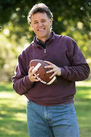 simsearch:700-00350524,k - Man Holding Football Stock Photo - Rights-Managed, Code: 700-00453389