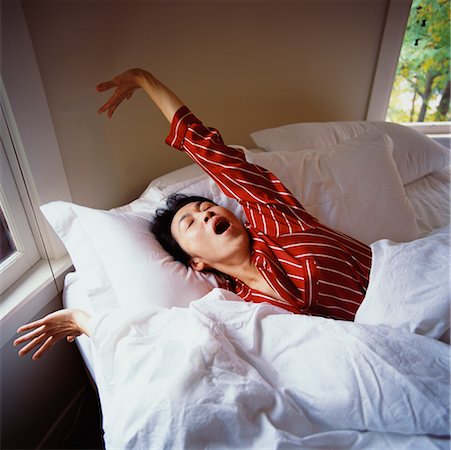 female lying on pillow arms raised images - Woman Waking Up Stock Photo - Rights-Managed, Code: 700-00453463