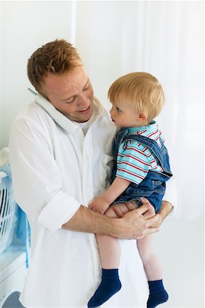 rolled up boy - Father Holding Son and Using Cordless Phone Stock Photo - Rights-Managed, Code: 700-00476762