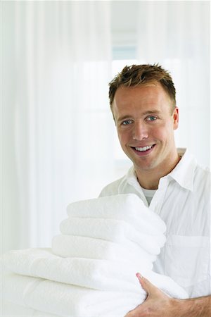 smelling laundry - Man Holding Stack of Folded Towels Stock Photo - Rights-Managed, Code: 700-00476785