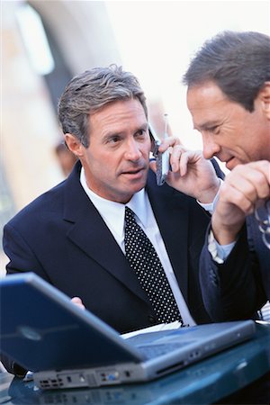 simsearch:700-00522448,k - Businessmen Using Laptop Computer, Talking on Cellular Phone Stock Photo - Rights-Managed, Code: 700-00477167