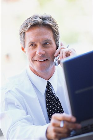 simsearch:700-00623019,k - Homme d'affaires avec ordinateur portable, parler au téléphone cellulaire Photographie de stock - Rights-Managed, Code: 700-00477181