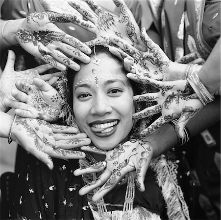 Portrait of Bride with Group of Hands Marked with Mendhi Fotografie stock - Rights-Managed, Codice: 700-00477576