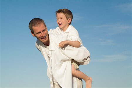 Father Giving Son Piggyback Ride Stock Photo - Rights-Managed, Code: 700-00514046