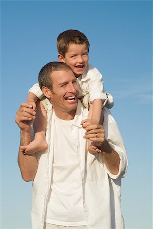 Boy Riding on Father's Shoulders Stock Photo - Rights-Managed, Code: 700-00514047