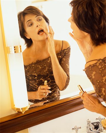 Woman Applying Make-up Stock Photo - Rights-Managed, Code: 700-00514870