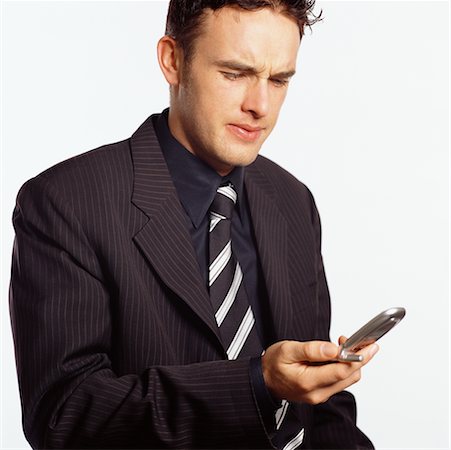 simsearch:600-02670099,k - Businessman Using Cellular Phone Foto de stock - Con derechos protegidos, Código: 700-00519601