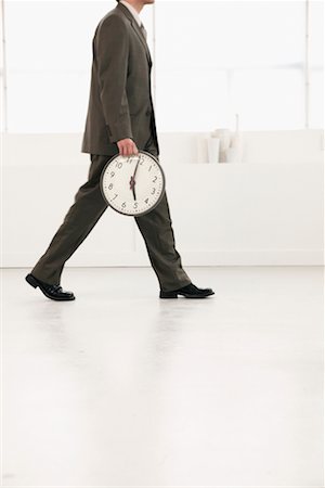 Businessman Leaving with Clock Stock Photo - Rights-Managed, Code: 700-00524484