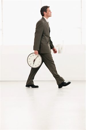 Businessman Leaving with Clock Stock Photo - Rights-Managed, Code: 700-00524485
