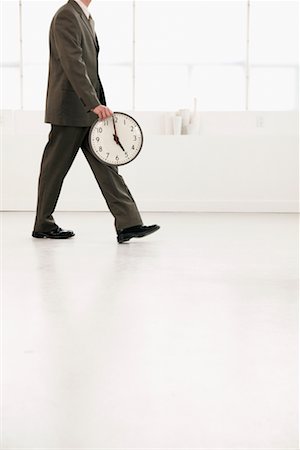 Businessman Leaving with Clock Stock Photo - Rights-Managed, Code: 700-00524483