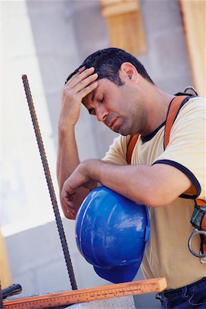 Travailleur de la construction avec des maux de tête Photographie de stock - Rights-Managed, Code: 700-00524890