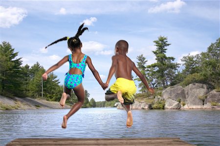 picture of two kids jumping into a lake - Children Jumping into Lake Stock Photo - Rights-Managed, Code: 700-00525035