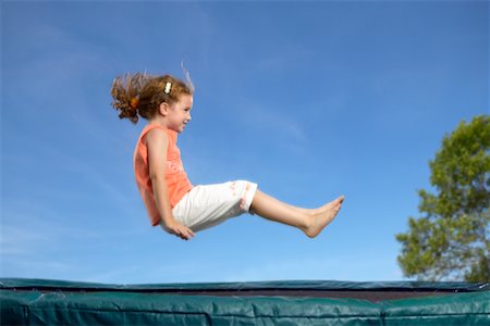 Girl Jumping on Trampoline Stock Photo - Rights-Managed, Code: 700-00525032