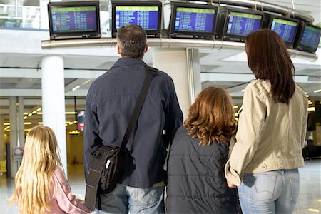 Family Watching Flight Data in Airport Stock Photo - Rights-Managed, Code: 700-00526578