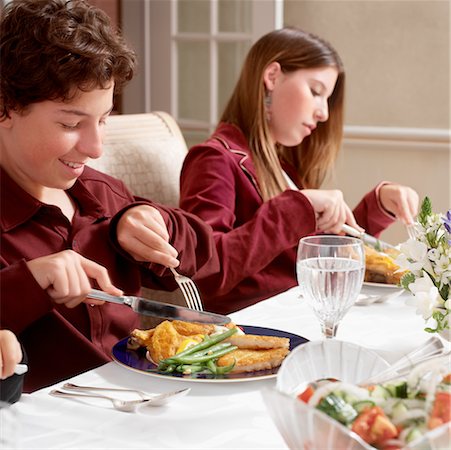 family eating chicken meat - Brother and Sister Eating Hanukkah Dinner Stock Photo - Rights-Managed, Code: 700-00527005