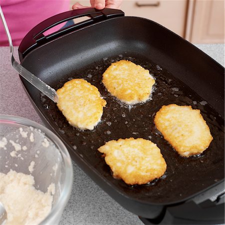 Potato Latkes Frying in a Pan Stock Photo - Rights-Managed, Code: 700-00527008