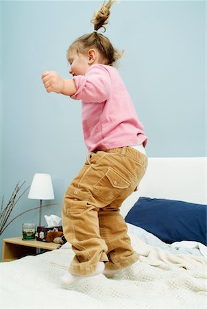 Child Jumping on Bed Stock Photo - Rights-Managed, Code: 700-00527107