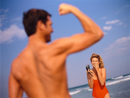Woman Photographing Man on Beach Stock Photo - Rights-Managed, Code: 700-00528378