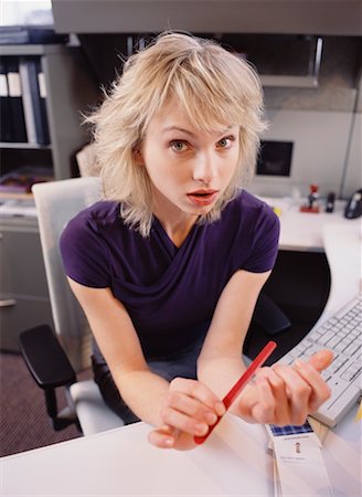 Businesswoman Filing Fingernails at Desk Stock Photo - Rights-Managed, Code: 700-00528784