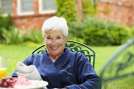 relaxing in the garden with a newspaper - Woman Reading Newspaper Outdoors Stock Photo - Rights-Managed, Code: 700-00529231
