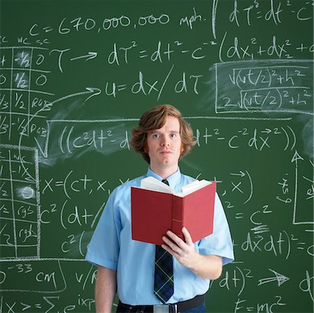 person reading a book confused - Man Standing in Front of Chalkboard with Equations Stock Photo - Rights-Managed, Code: 700-00529395