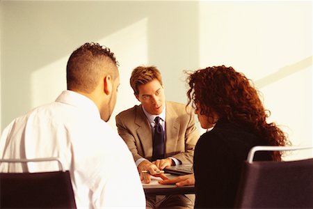 financial advisor talking to couple - Financial Advisor Meeting with Young Couple Stock Photo - Rights-Managed, Code: 700-00529575