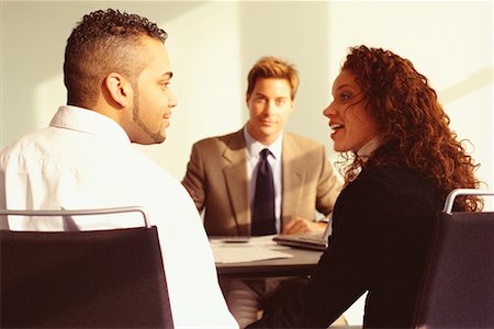 financial advisor talking to couple - Young Couple Meeting with Financial Advisor Foto de stock - Con derechos protegidos, Código: 700-00529572