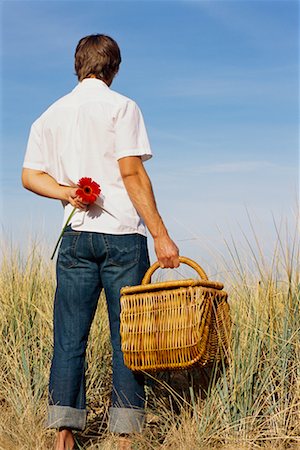dimorphotheca - Man Holding Picnic Basket and Flower Stock Photo - Rights-Managed, Code: 700-00529613