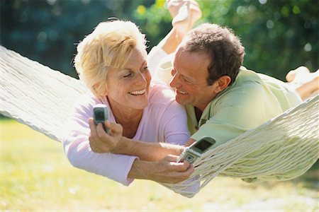 Couple in Hammock with Cellular Phones Stock Photo - Rights-Managed, Code: 700-00529924