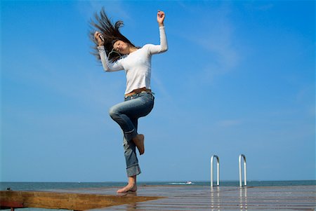 Woman Standing on Dock, Using MP3 Player Stock Photo - Rights-Managed, Code: 700-00520117