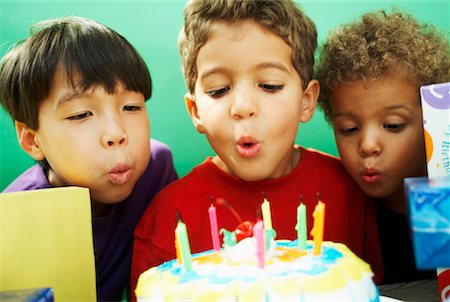 Boys Blowing Out Candles on Birthday Cake Stock Photo - Rights-Managed, Code: 700-00520543