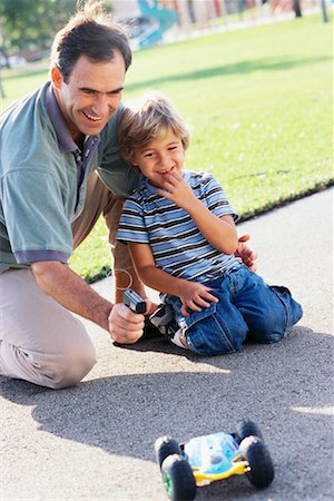 remote control toy - Father and Son Playing With Remote Controlled Car Stock Photo - Rights-Managed, Code: 700-00522347