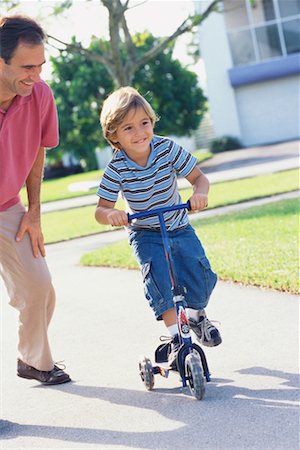 simsearch:700-00522354,k - Father with Son Riding Scooter Stock Photo - Rights-Managed, Code: 700-00522351