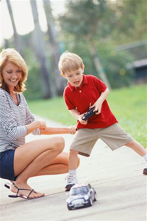 skirt squat - Mother and Son with Remote Control Car Stock Photo - Rights-Managed, Code: 700-00522363